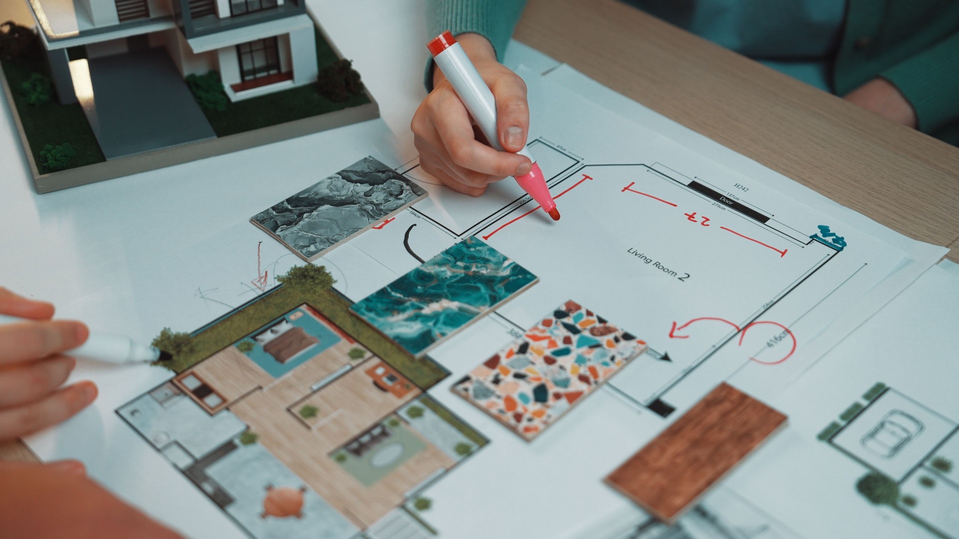 Creative Planning Session for Home Design with Colorful Samples and Sketches on a Table Featuring Architectural Drawings and Models SACTR
