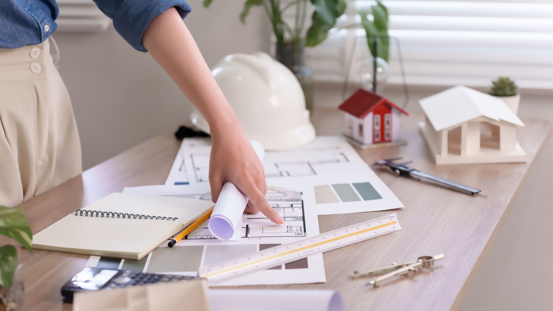 Asian Woman Hand Inspecting Blueprint for Building Design Project House Plan Renovation with Architect Tools for Planning and Architecture Project for Property Business